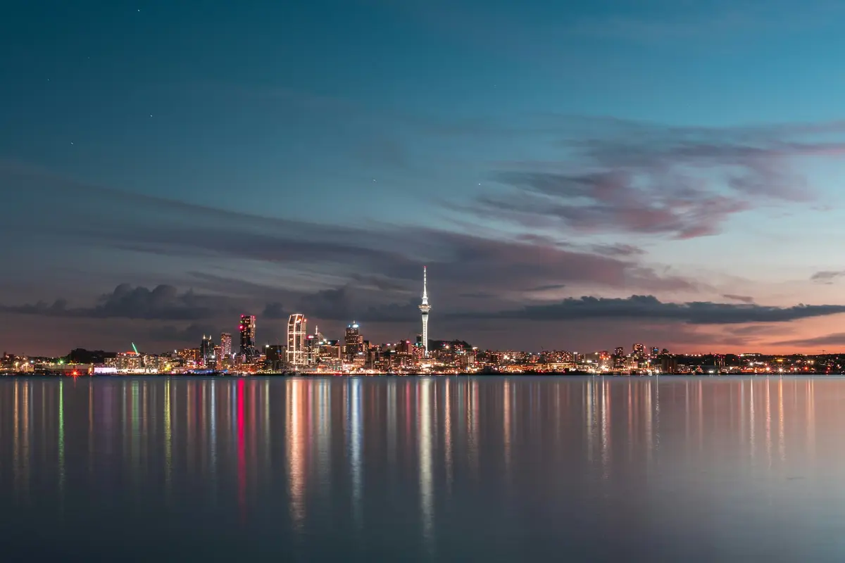 Auckland city skyline across the harbour at dusk from Northcote
