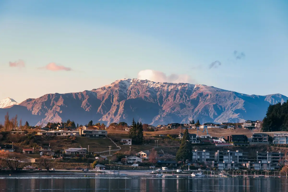 Lakeside town with mountains in the background