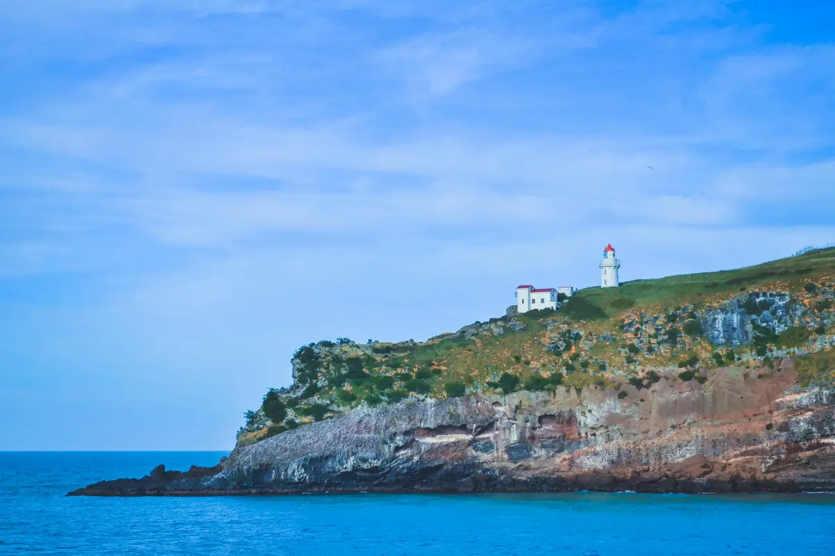 Lighthouse on a rocky point near Port Chalmers, Otago