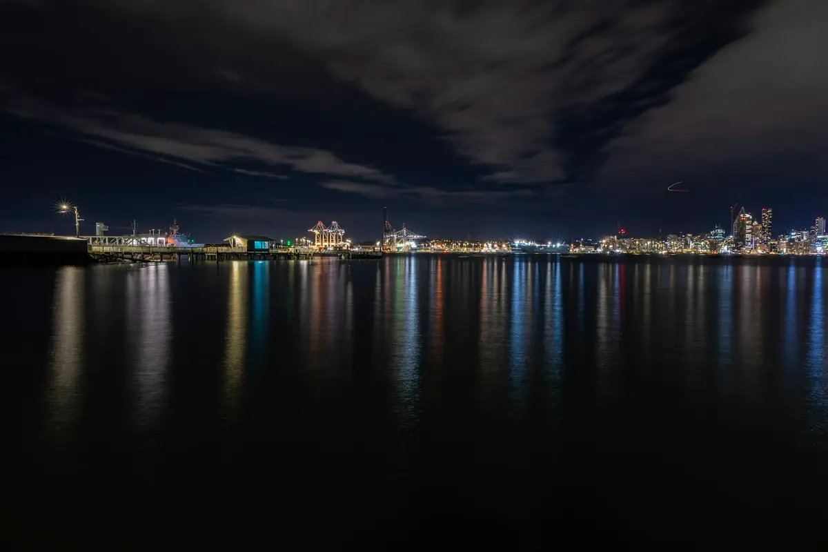 Auckland skyline lights reflected on the harbour at night