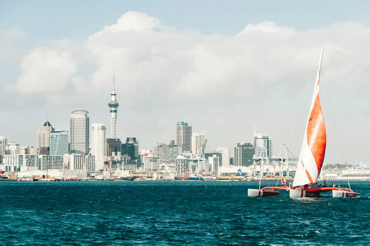 Trimaran sailing on the Hauraki Gulf with Auckland's CBD skyline behind